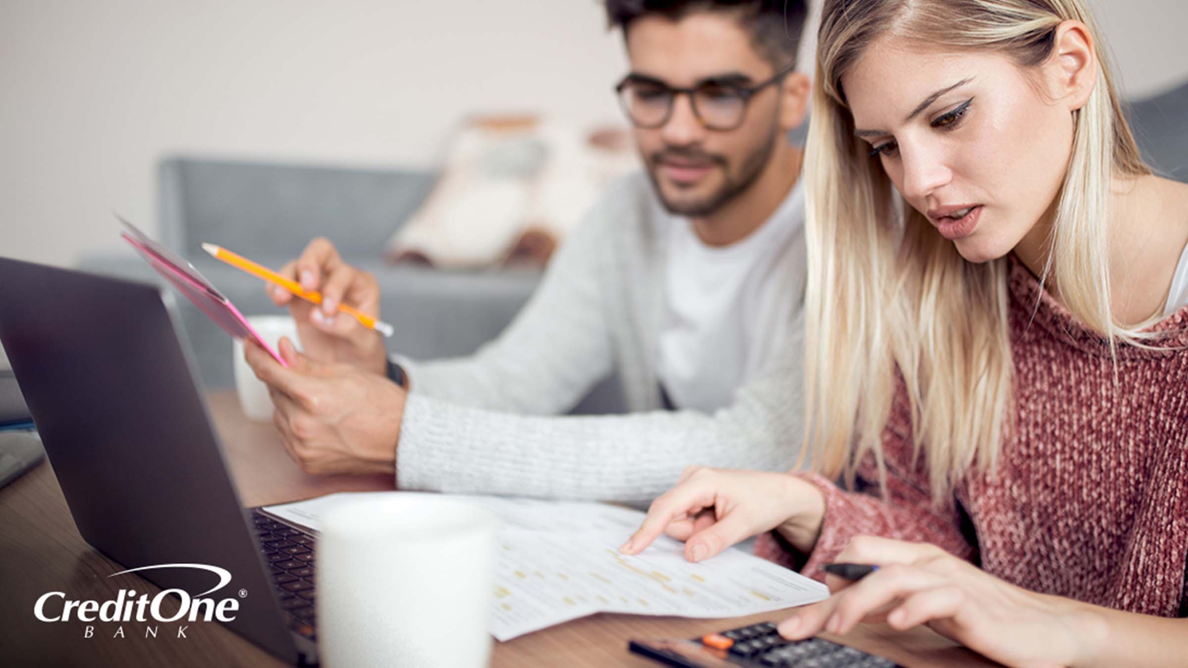 A young couple checking their credit and reviewing their financial statements